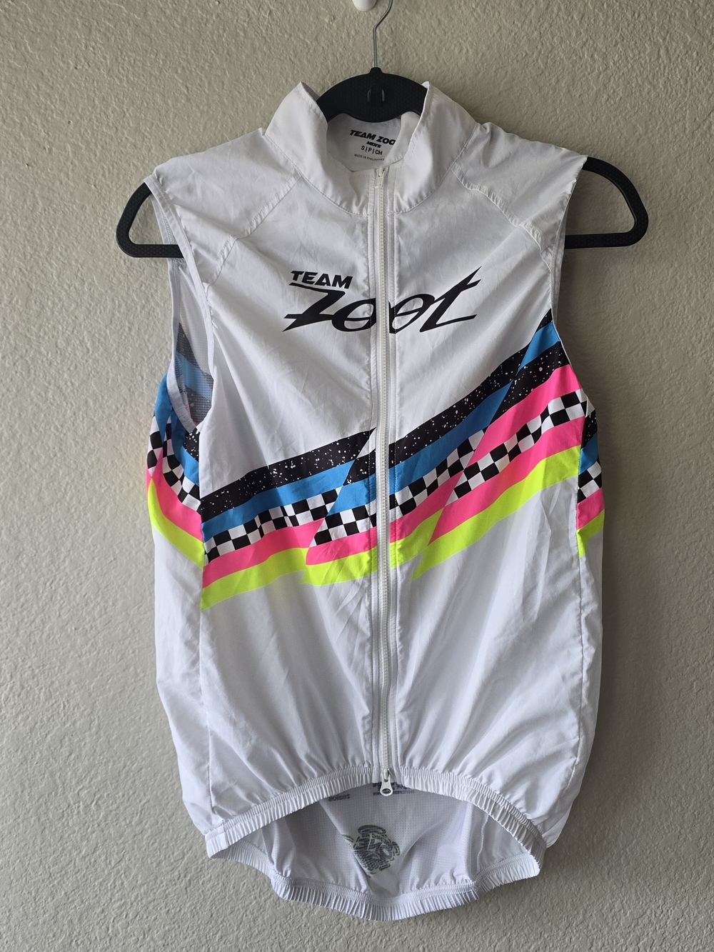 Zoot White Cycling Vest with Neon Pink, Neon Yellow, Blue and Black Accents